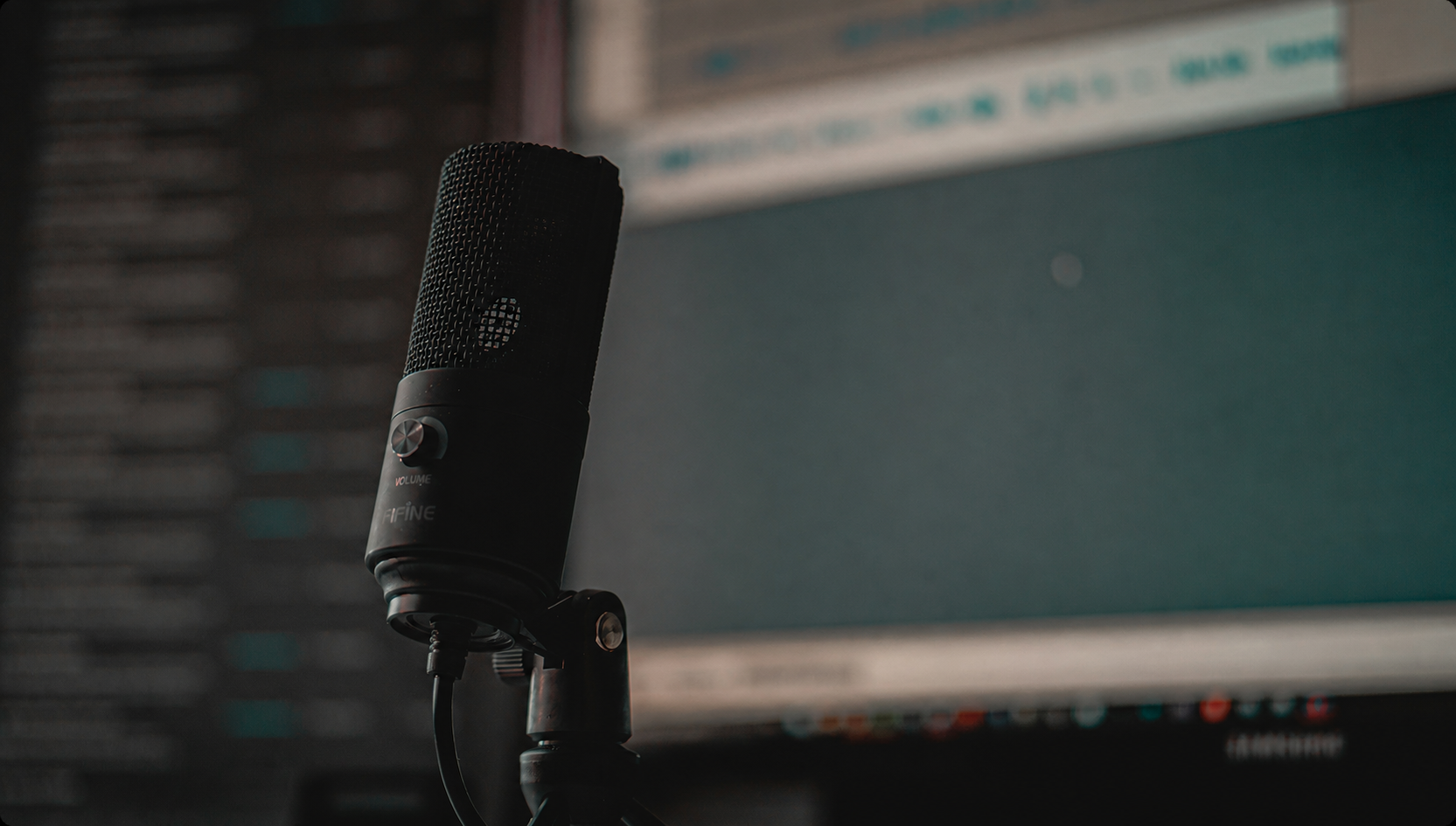 Studio microphone in front of an audio editing screen
